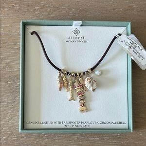 Atterri charm necklace with fish, shells, and freshwater pearl